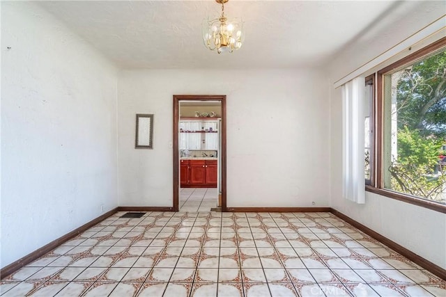 2439 California St, Walnut Park, CA 90255 - spare room featuring a chandelier and light floors