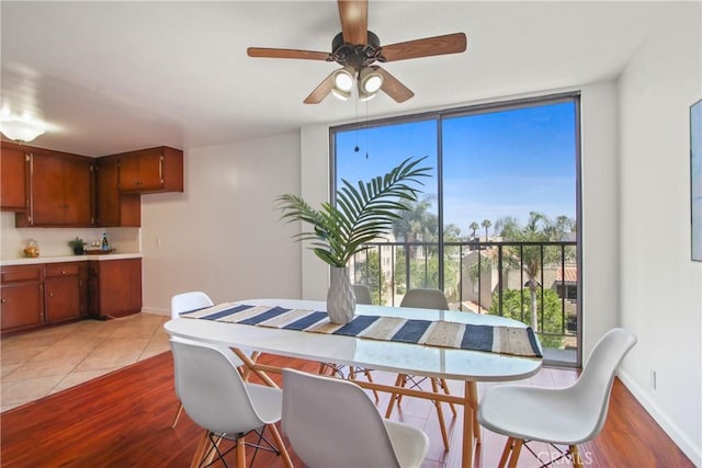 545 Chestnut Ave Unit 411, Long Beach, CA 90802 - dining room with ceiling fan, light wood-style floors, and a wall of windows