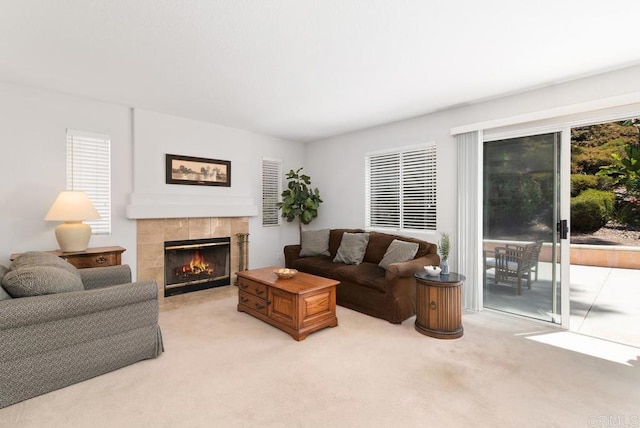 4356 Point Reyes Ct, Carlsbad, CA 92010 - living room with light carpet, a tiled fireplace, and plenty of natural light