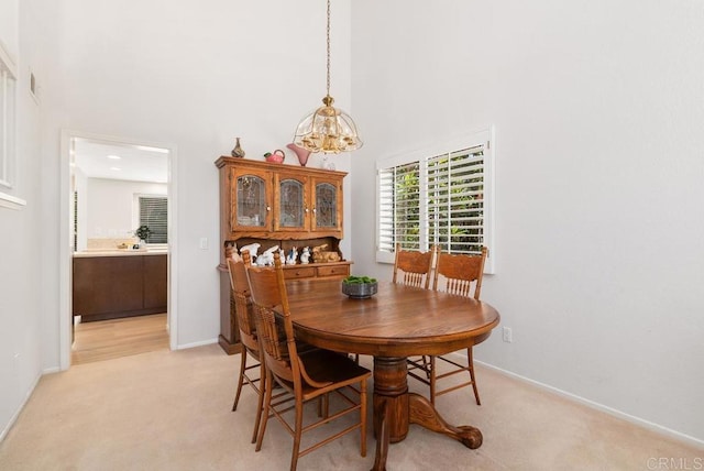 4356 Point Reyes Ct, Carlsbad, CA 92010 - dining room featuring a high ceiling, a chandelier, and light colored carpet