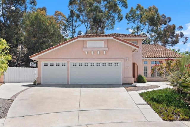 4356 Point Reyes Ct, Carlsbad, CA 92010 - mediterranean / spanish-style home featuring driveway, stucco siding, a garage, and a tiled roof