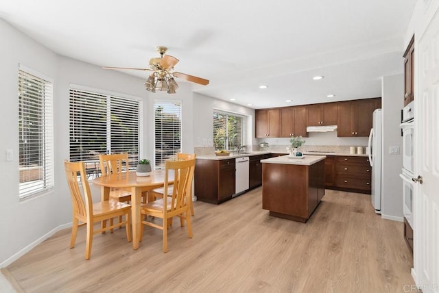 4356 Point Reyes Ct, Carlsbad, CA 92010 - kitchen with a kitchen island, ceiling fan, under cabinet range hood, white appliances, and light wood-type flooring