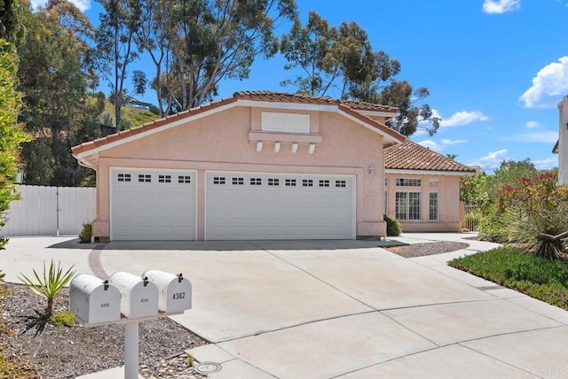 4356 Point Reyes Ct, Carlsbad, CA 92010 - mediterranean / spanish home featuring concrete driveway, a tiled roof, stucco siding, and a garage