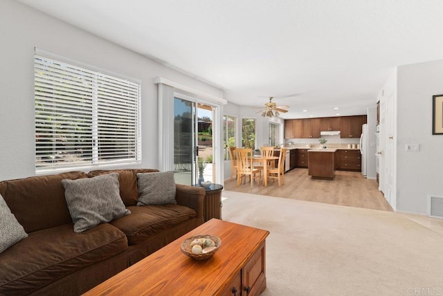4356 Point Reyes Ct, Carlsbad, CA 92010 - living area with ceiling fan, light colored carpet, and light wood-type flooring