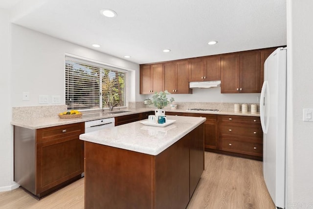 4356 Point Reyes Ct, Carlsbad, CA 92010 - kitchen featuring white appliances, under cabinet range hood, light wood-style floors, a kitchen island, and recessed lighting
