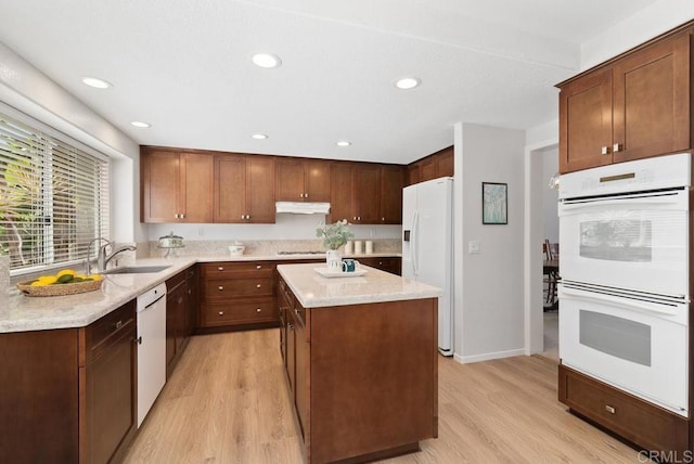 4356 Point Reyes Ct, Carlsbad, CA 92010 - kitchen featuring white appliances, light wood-style flooring, under cabinet range hood, a kitchen island, and recessed lighting