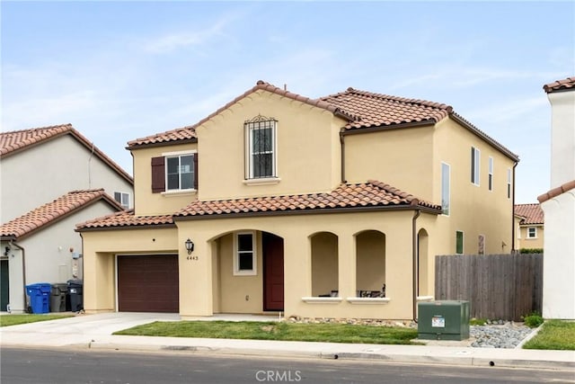 4443 Manzanita St, Guadalupe, CA 93434 - mediterranean / spanish-style house featuring concrete driveway, stucco siding, a porch, and a tile roof