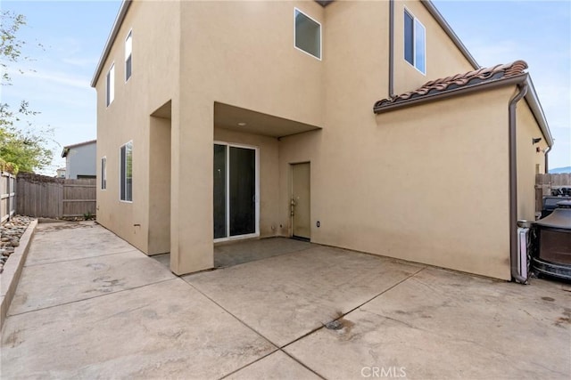 4443 Manzanita St, Guadalupe, CA 93434 - rear view of house with stucco siding, a patio area, and a tiled roof