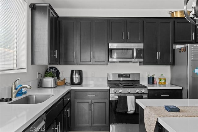 4443 Manzanita St, Guadalupe, CA 93434 - kitchen with stainless steel appliances, dark cabinets, and light countertops