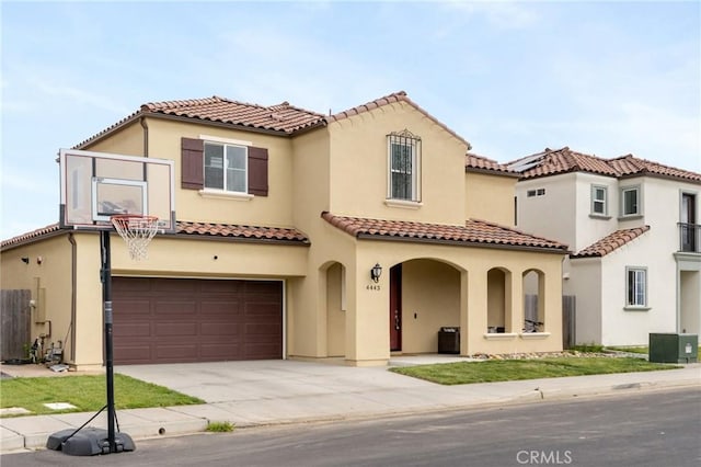 4443 Manzanita St, Guadalupe, CA 93434 - mediterranean / spanish house featuring an attached garage, stucco siding, concrete driveway, and a tiled roof