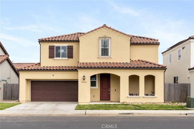 4443 Manzanita St, Guadalupe, CA 93434 - mediterranean / spanish-style home featuring stucco siding, covered porch, driveway, a tile roof, and an attached garage