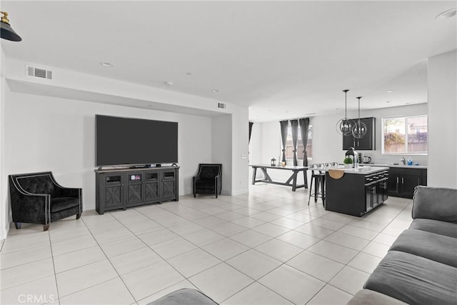 4443 Manzanita St, Guadalupe, CA 93434 - living area with light tile patterned floors, a chandelier, and recessed lighting