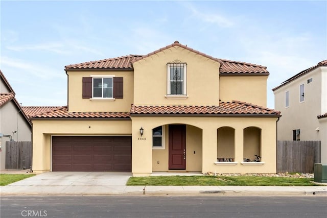 4443 Manzanita St, Guadalupe, CA 93434 - mediterranean / spanish-style home featuring driveway, stucco siding, covered porch, a tiled roof, and an attached garage