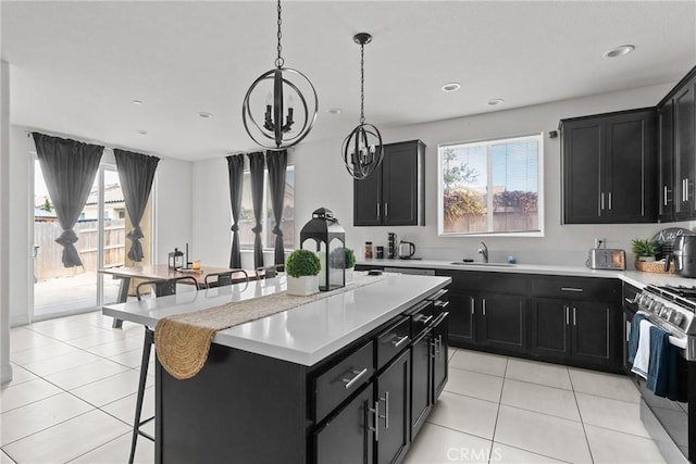 4443 Manzanita St, Guadalupe, CA 93434 - kitchen with dark cabinets, gas range, a chandelier, and recessed lighting