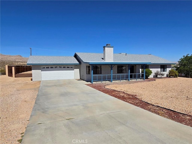7050 Ivanpah Ave Unit 29, Palms, CA 92277 - single story home featuring a garage, concrete driveway, a chimney, covered porch, and stucco siding