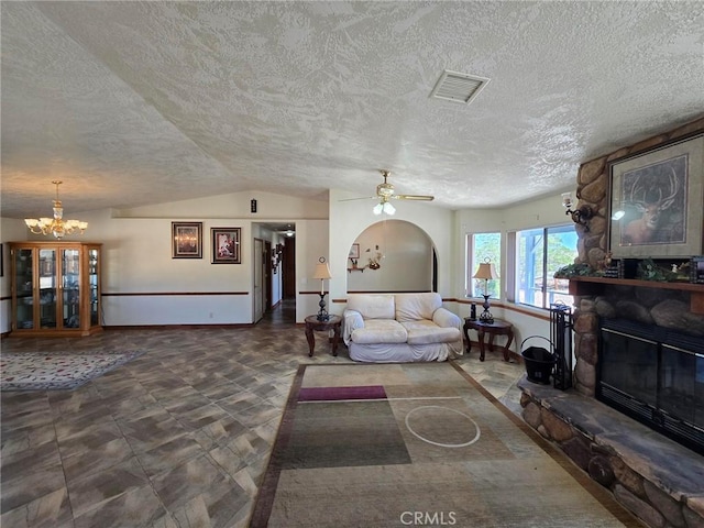 7050 Ivanpah Ave Unit 29, Palms, CA 92277 - living room featuring a textured ceiling, a fireplace, a ceiling fan, lofted ceiling, and a chandelier