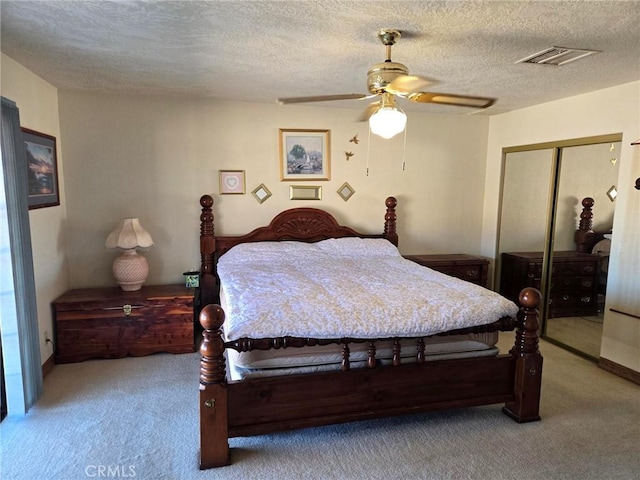 7050 Ivanpah Ave Unit 29, Palms, CA 92277 - bedroom featuring carpet flooring, a closet, a textured ceiling, and a ceiling fan