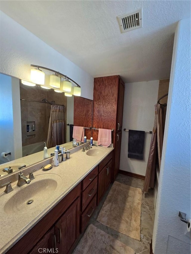 7050 Ivanpah Ave Unit 29, Palms, CA 92277 - bathroom with double vanity and a textured ceiling