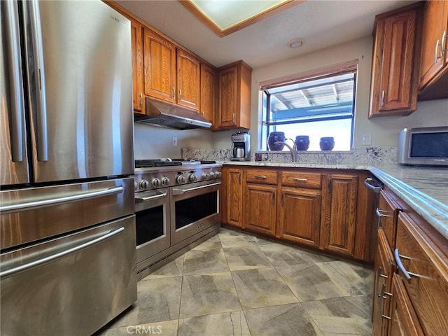 7050 Ivanpah Ave Unit 29, Palms, CA 92277 - kitchen with appliances with stainless steel finishes, under cabinet range hood, and brown cabinetry
