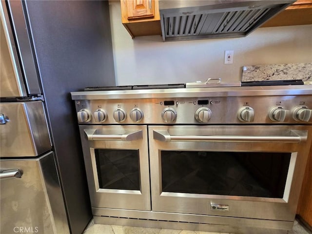 7050 Ivanpah Ave Unit 29, Palms, CA 92277 - kitchen view of appliances with stainless steel finishes and range hood