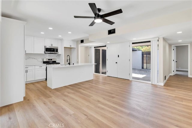 7364 Layton St, Rancho Cucamonga, CA 91730 - kitchen with appliances with stainless steel finishes, white cabinets, light wood-style floors, light countertops, and recessed lighting