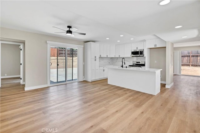 7364 Layton St, Rancho Cucamonga, CA 91730 - kitchen with stainless steel appliances, a ceiling fan, white cabinets, light countertops, and recessed lighting