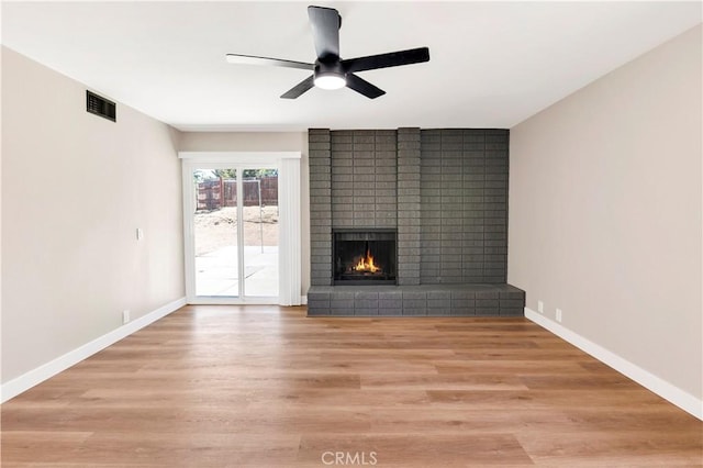7364 Layton St, Rancho Cucamonga, CA 91730 - unfurnished living room featuring a ceiling fan, a brick fireplace, and light wood-style floors