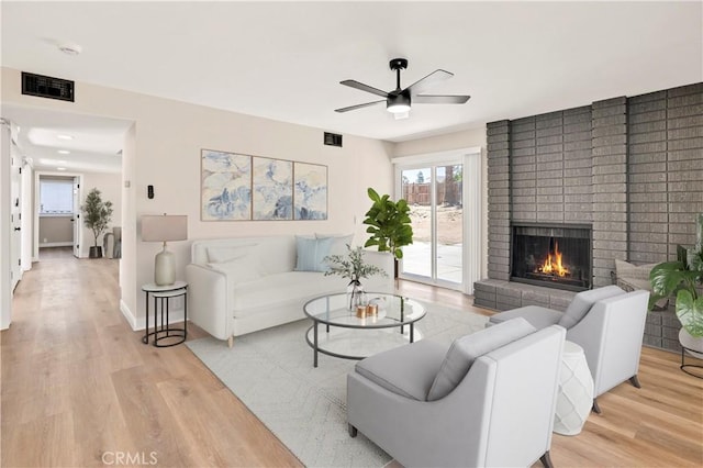 7364 Layton St, Rancho Cucamonga, CA 91730 - living room with a ceiling fan, light wood-type flooring, and a fireplace