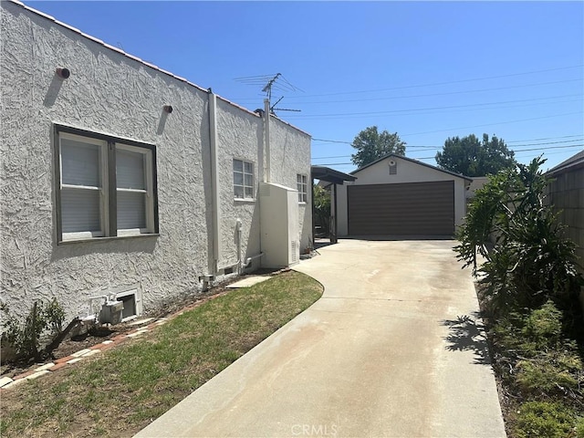 1316 Elm St, Alhambra, CA 91803 - view of property exterior with stucco siding, an outdoor structure, and a detached garage