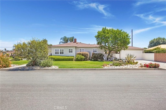 829 N Foxdale Ave, West Covina, CA 91790 - single story home with an attached garage, concrete driveway, a front yard, a chimney, and stucco siding