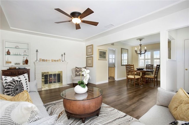 829 N Foxdale Ave, West Covina, CA 91790 - living room with a chandelier, wood finished floors, ceiling fan, and a brick fireplace