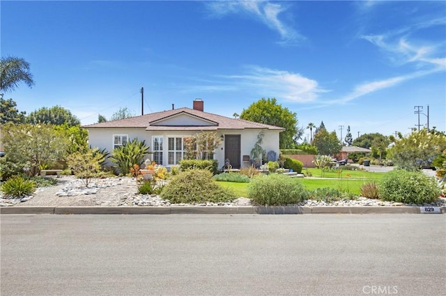 829 N Foxdale Ave, West Covina, CA 91790 - view of front of house featuring stucco siding and a chimney