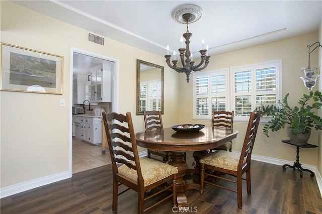 829 N Foxdale Ave, West Covina, CA 91790 - dining area featuring a chandelier, healthy amount of natural light, and dark wood-style flooring