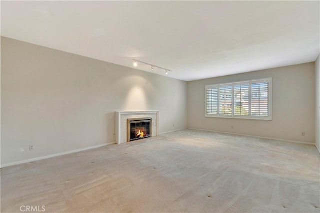1318 Sao Paulo Ave, Placentia, CA 92870 - unfurnished living room with rail lighting, light colored carpet, and a premium fireplace
