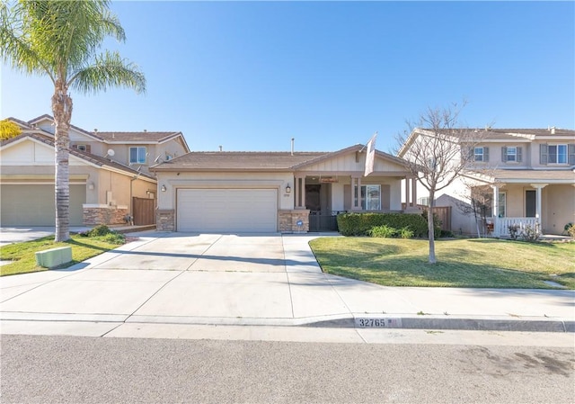32765 Santa Cruz, Lake Elsinore, CA 92530 - view of front of house featuring a garage, driveway, stucco siding, and stone siding