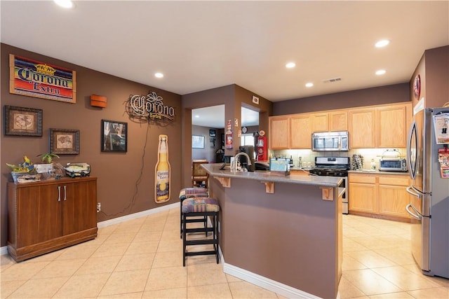 32765 Santa Cruz, Lake Elsinore, CA 92530 - kitchen with stainless steel appliances, recessed lighting, a breakfast bar, light brown cabinetry, and light tile patterned floors