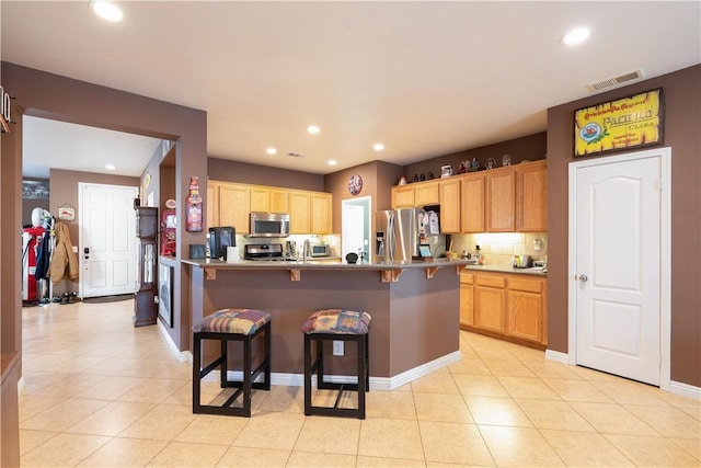 32765 Santa Cruz, Lake Elsinore, CA 92530 - kitchen featuring stainless steel appliances, a breakfast bar, tasteful backsplash, recessed lighting, and a peninsula
