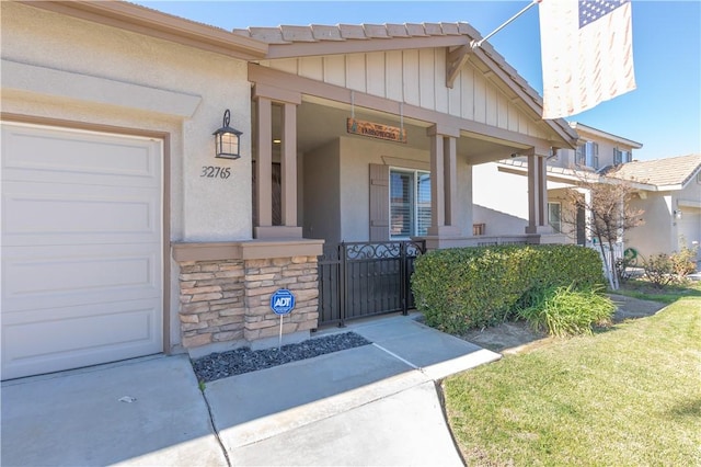 32765 Santa Cruz, Lake Elsinore, CA 92530 - property entrance featuring a porch, a garage, stone siding, and stucco siding
