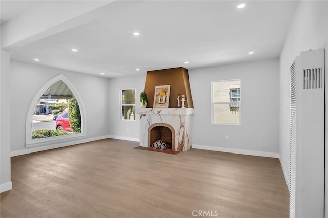 2049 W 71st St, Los Angeles, CA 90047 - unfurnished living room featuring a heating unit, wood finished floors, recessed lighting, and a fireplace