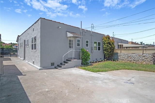 2049 W 71st St, Los Angeles, CA 90047 - back of house with stucco siding and crawl space