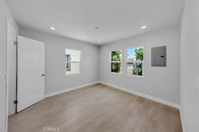 2049 W 71st St, Los Angeles, CA 90047 - spare room featuring electric panel, light wood-style floors, and recessed lighting