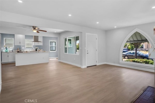 2049 W 71st St, Los Angeles, CA 90047 - unfurnished living room with light wood-style floors, ceiling fan, and recessed lighting
