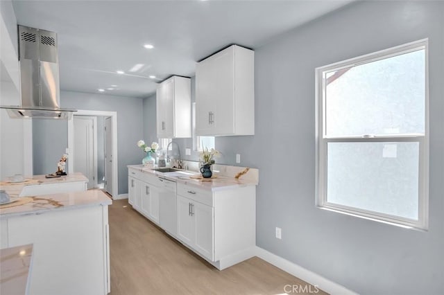 2049 W 71st St, Los Angeles, CA 90047 - kitchen with island exhaust hood, dishwasher, light wood finished floors, white cabinetry, and recessed lighting