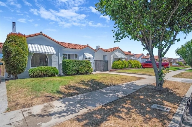 2049 W 71st St, Los Angeles, CA 90047 - mediterranean / spanish house featuring a tile roof and stucco siding