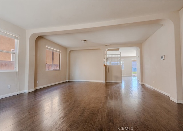 11818 Forest Park Ln, Victorville, CA 92392 - unfurnished room featuring arched walkways, wood finished floors, and plenty of natural light