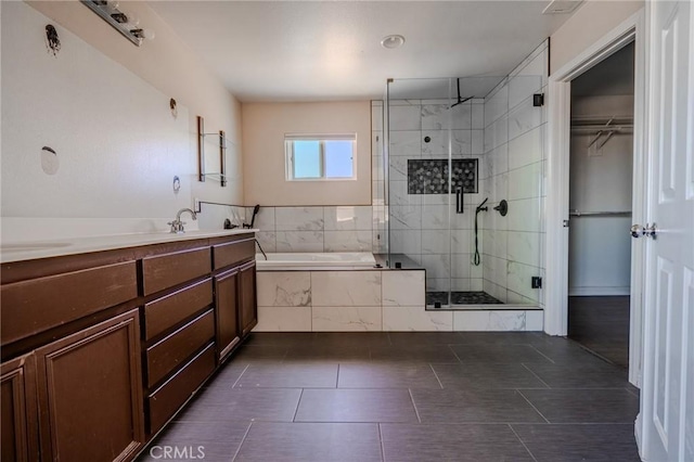 11818 Forest Park Ln, Victorville, CA 92392 - bathroom with a garden tub, a shower stall, tile patterned floors, double vanity, and a walk in closet