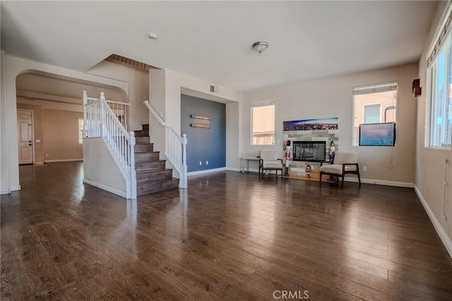 11818 Forest Park Ln, Victorville, CA 92392 - living room with stairway, wood finished floors, a glass covered fireplace, and healthy amount of natural light