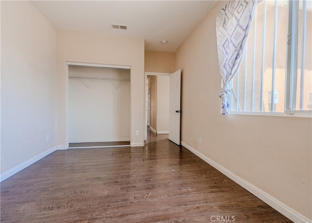 11818 Forest Park Ln, Victorville, CA 92392 - unfurnished bedroom with wood finished floors and a closet