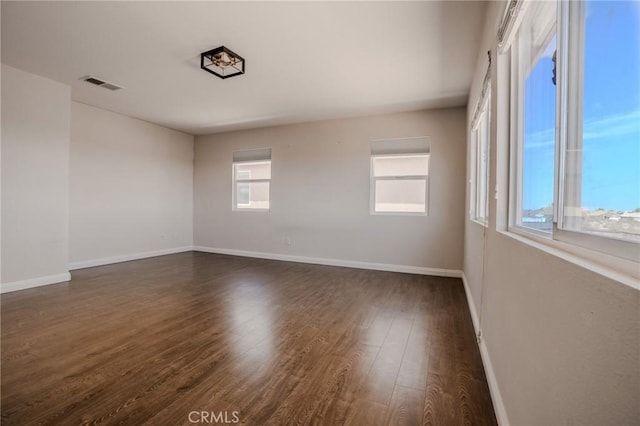 11818 Forest Park Ln, Victorville, CA 92392 - spare room featuring dark wood finished floors and baseboards