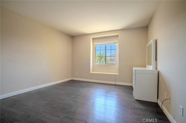 11818 Forest Park Ln, Victorville, CA 92392 - spare room featuring dark wood-style floors and baseboards
